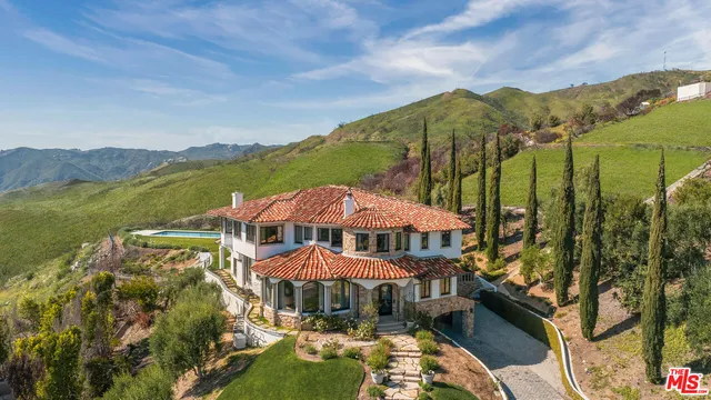 a view of a patio with furniture and a yard