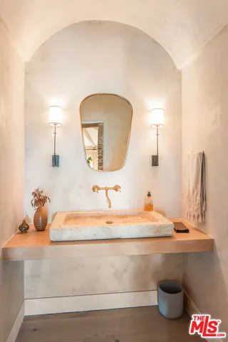 a spacious bedroom with a bed and glass walk in closet