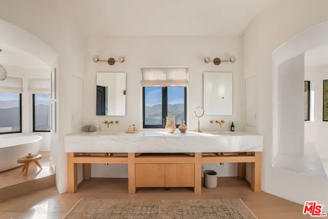 a room with two chairs and a chandelier