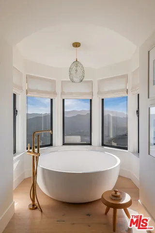 wooden floor in a en suite bathroom next to a window