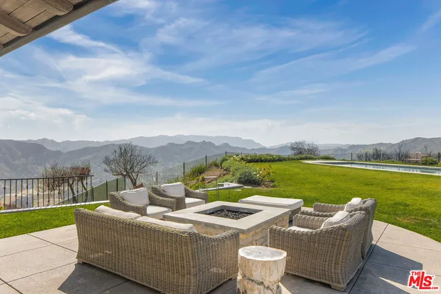 a view of a house with a table and chairs