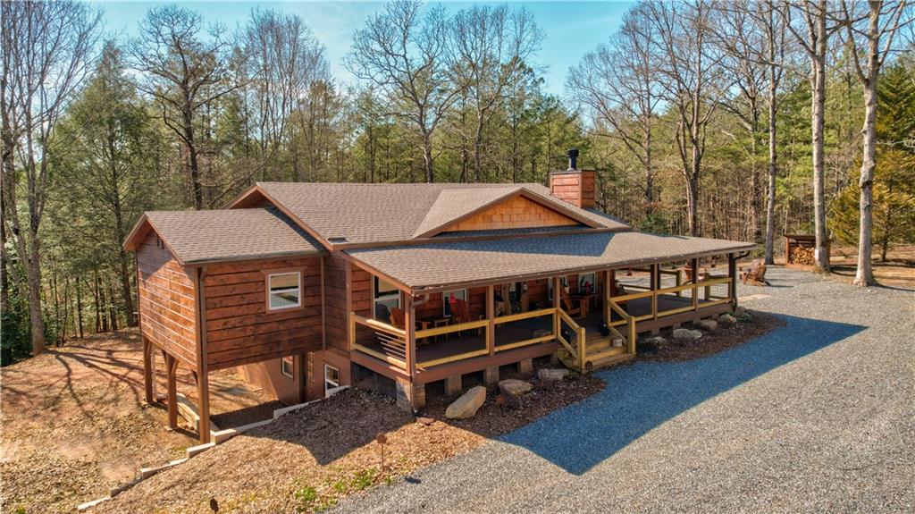 802 New Hope Club Road Ellijay, GA 30540 - Photo 1 of 1 a roof deck with table and chairs under an umbrella