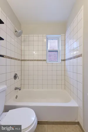 a bathroom with a bathtub and a toilet