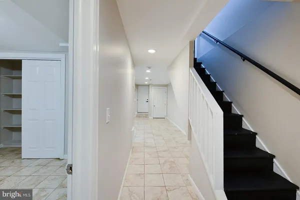a view of hallway with a window and a bathroom