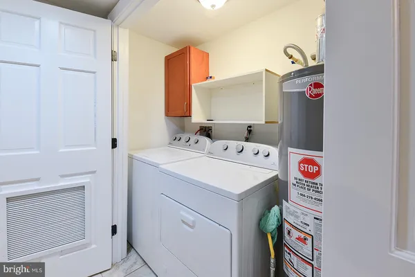 a kitchen with a stove top oven and cabinets