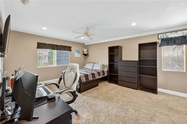 a bedroom with a bed and a television