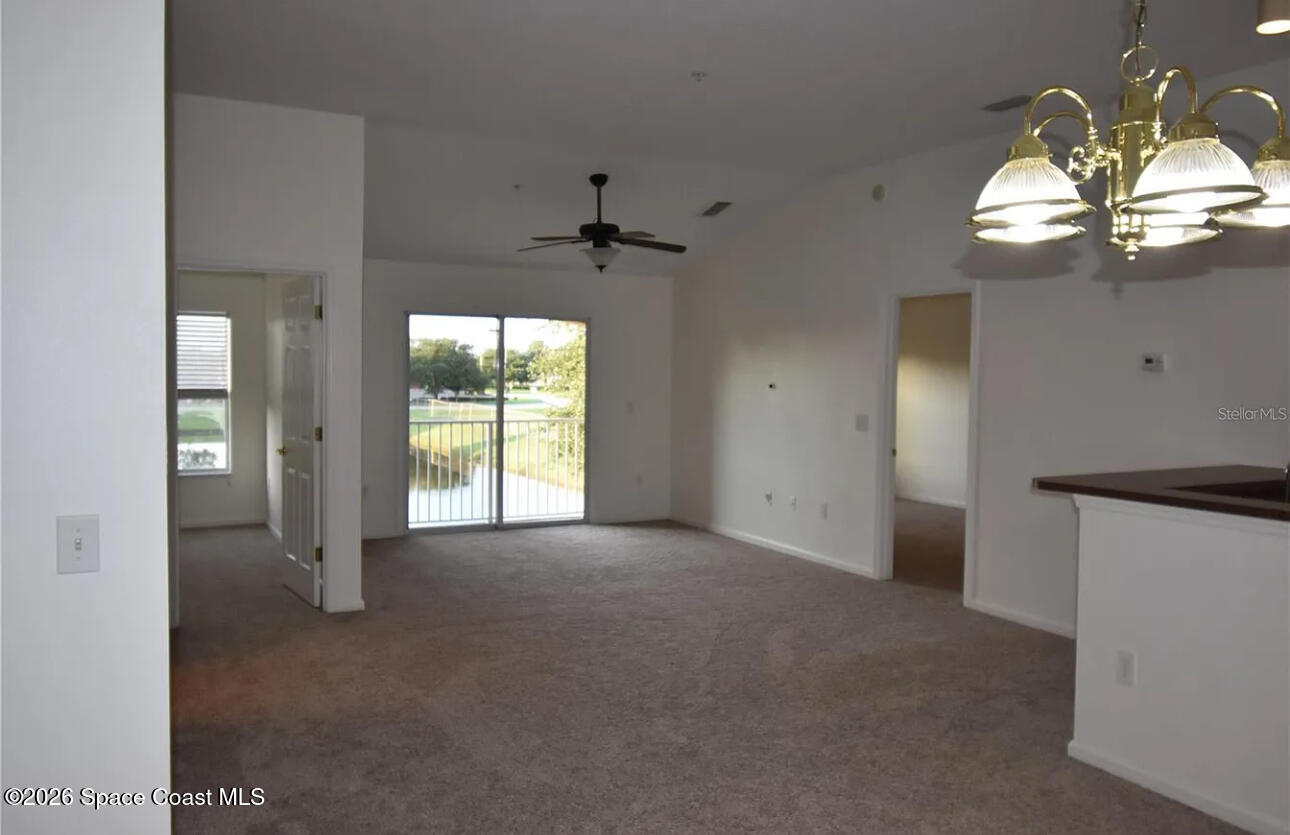 4117 Meander Place, Unit 206 Rockledge, FL 32955 - Photo 3 of 15 a view of a livingroom with a chandelier fan and windows