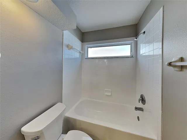 a bathroom with a bathtub and toilet