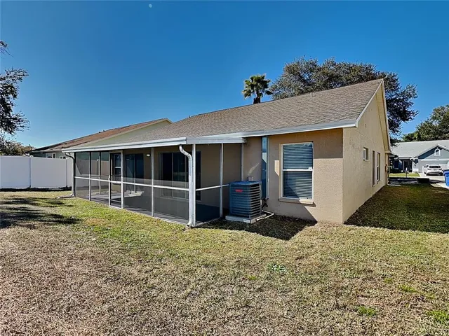 a view of a house with a yard and sitting area