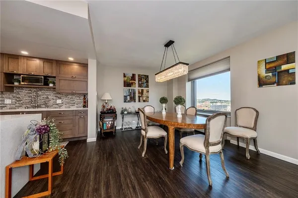a view of a dining room with furniture and wooden floor