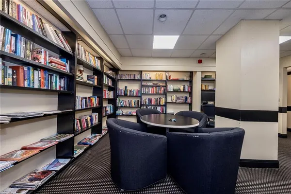 a living room with furniture and a book shelf