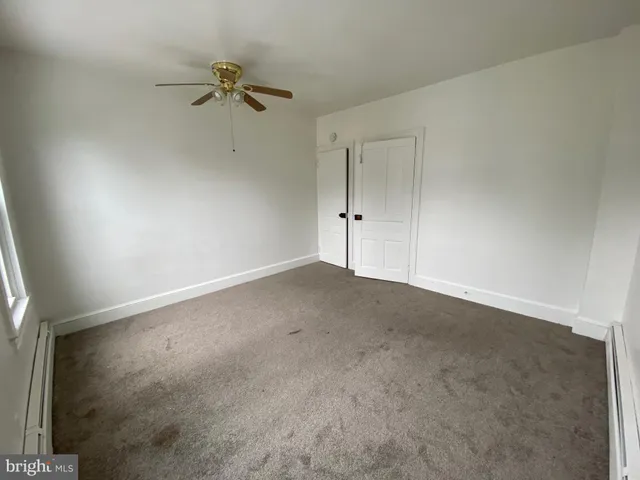 a view of a room with a ceiling fan