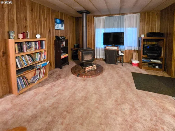 a living room with furniture a flat screen tv and a book shelf