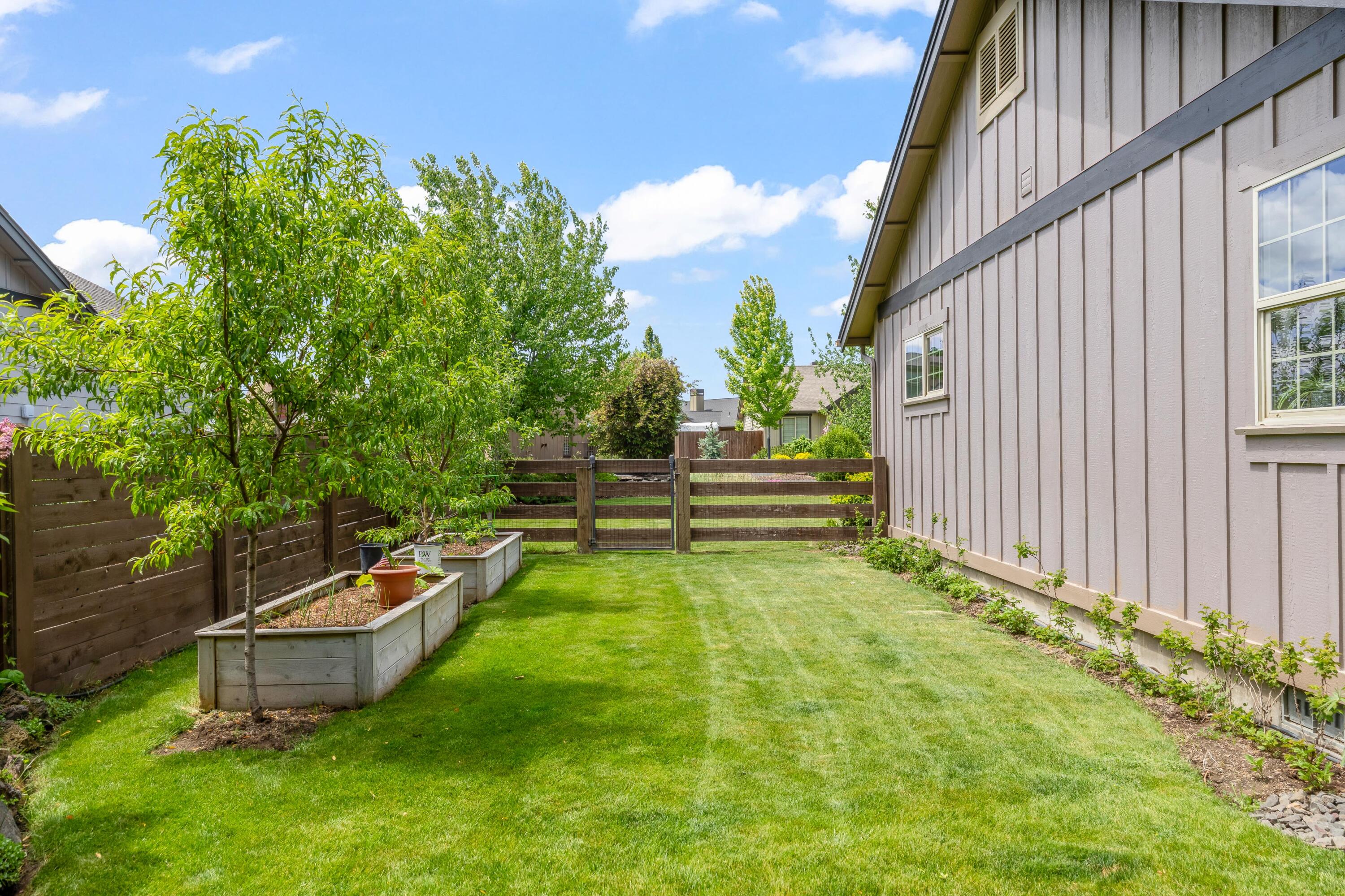 210 Northwest Saddle Ridge Loop Prineville, OR 97754 - Photo 27 of 38 a backyard of a house with table and chairs