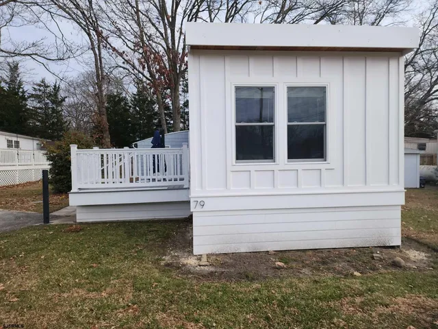 a view of a house with a yard and sitting area