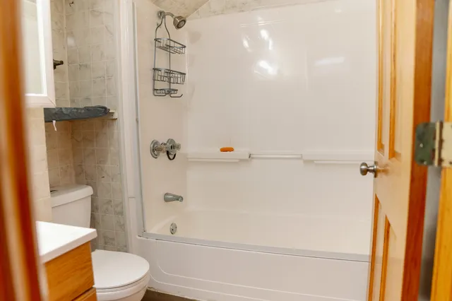 a bathroom with a toilet and a shower