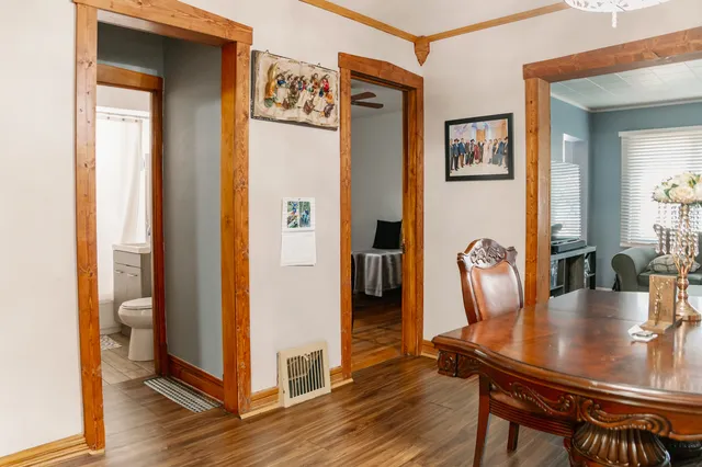 a dining room with furniture and wooden floor