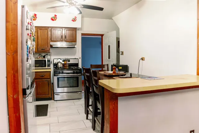 a kitchen with stainless steel appliances a sink and a refrigerator
