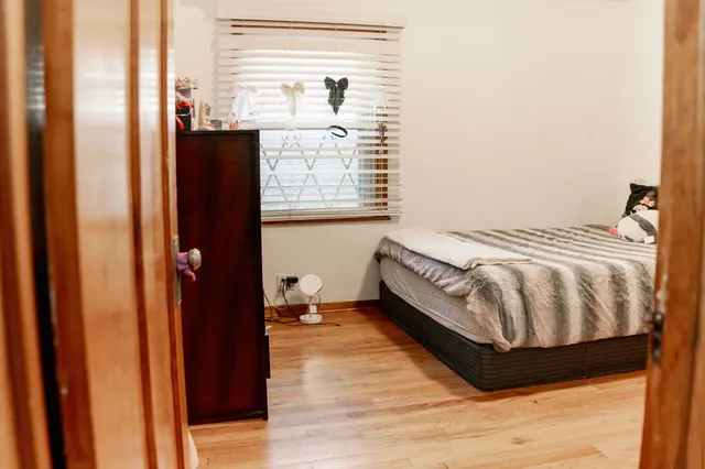 a bedroom with a bed and window