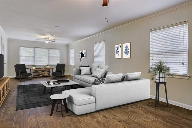 a living room with furniture and a wooden floor