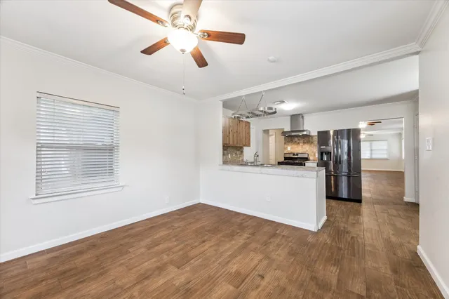 a view of kitchen with stainless steel appliances refrigerator stove microwave and cabinets