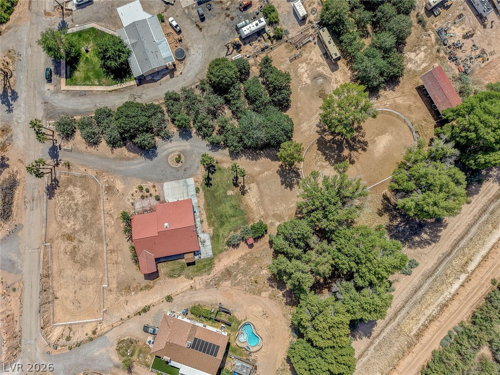 1950 Bowman Road Logandale, NV 89021 - Photo 73 of 81 An aerial perspective showcases a spacious property with multiple structures, mature trees, and ample open land.