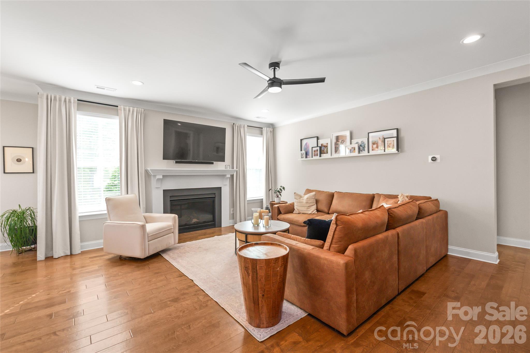 3213 Timber Run Lane Maiden, NC 28650 - Photo 25 of 47 a living room with furniture a fireplace and a flat screen tv