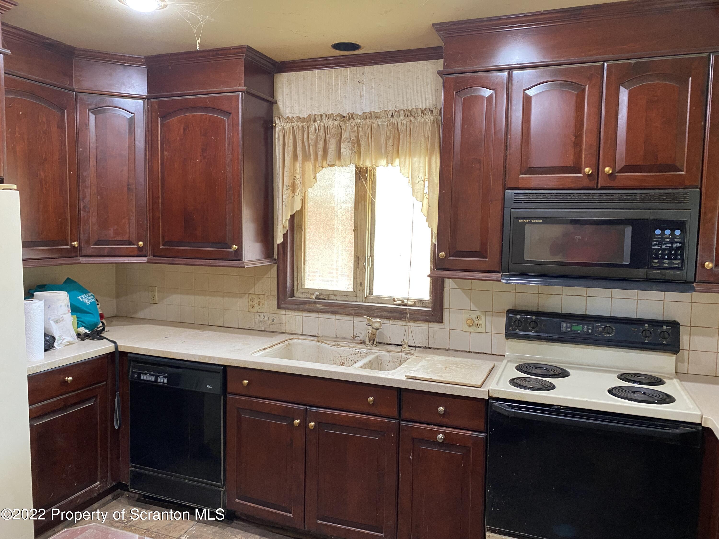 2008 South Webster Avenue Scranton, PA 18505 - Photo 11 of 37 a kitchen with a sink a stove and cabinets