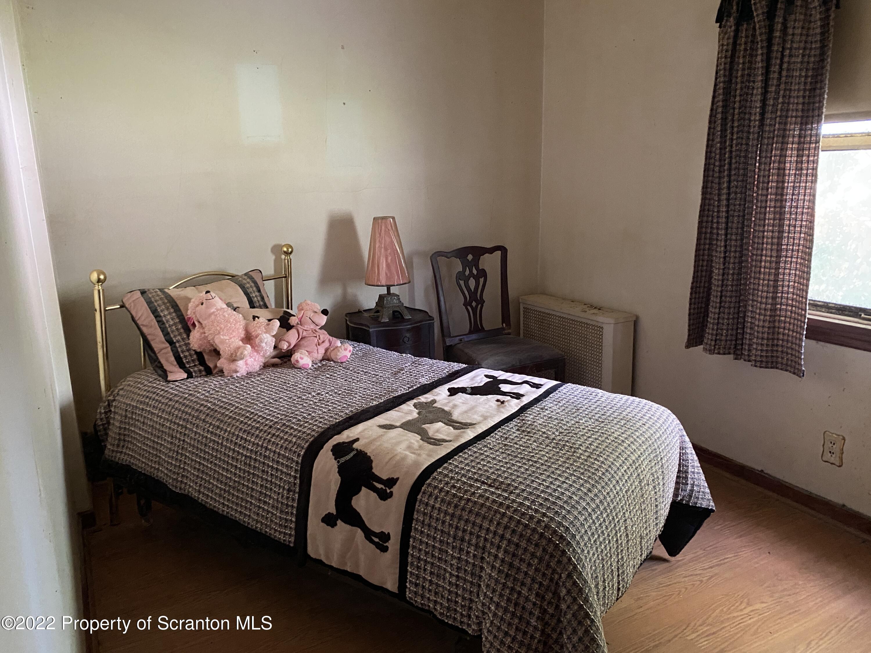 2008 South Webster Avenue Scranton, PA 18505 - Photo 14 of 37 a bedroom with a bed and wooden floor