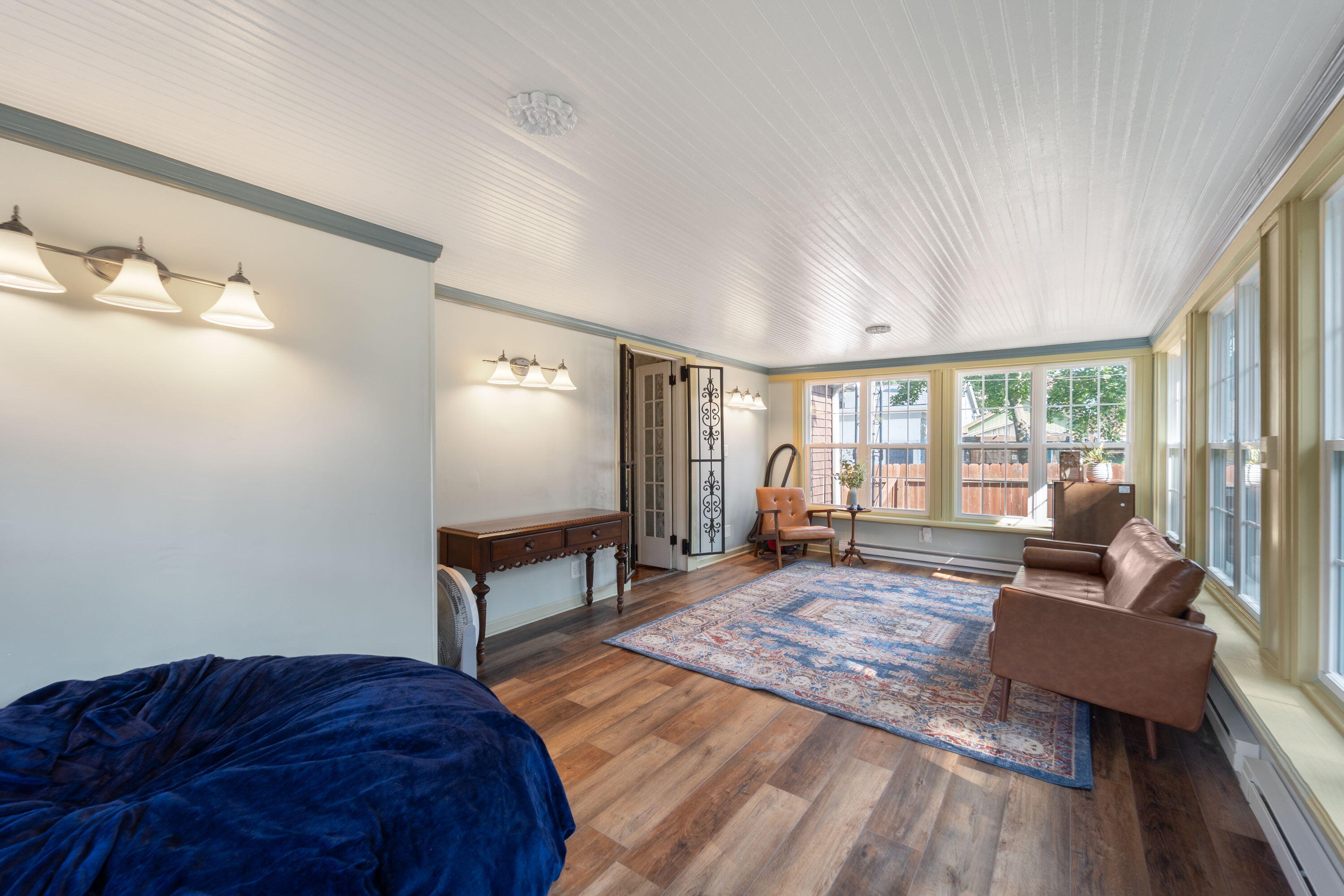 1213 College Avenue Racine, WI 53403 - Photo 11 of 31 Charming 3-seasons room with panoramic backyard views—perfect for savoring snowy winter scenes or vibrant summer days.