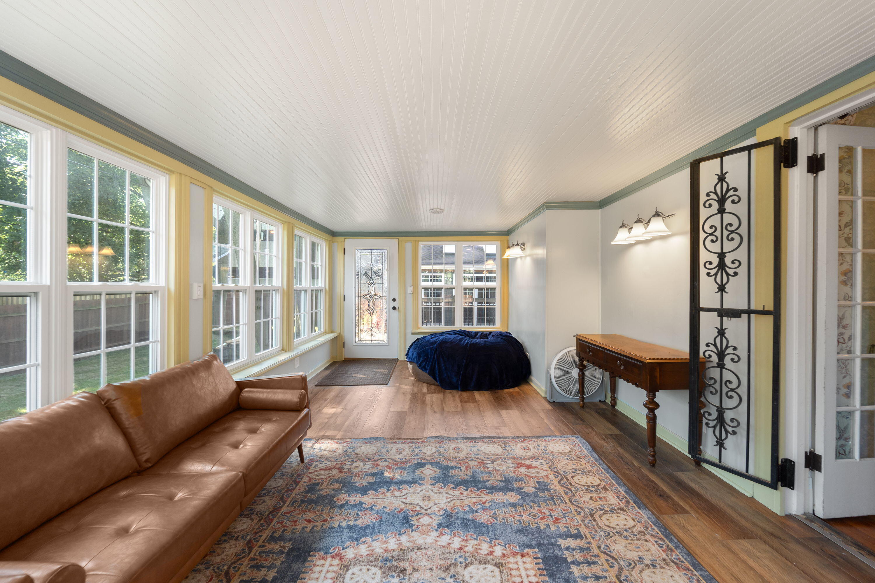 1213 College Avenue Racine, WI 53403 - Photo 12 of 31 Inviting sunroom that brings the outdoors in, overlooking the picturesque backyard, with beautifully restored details throughout.