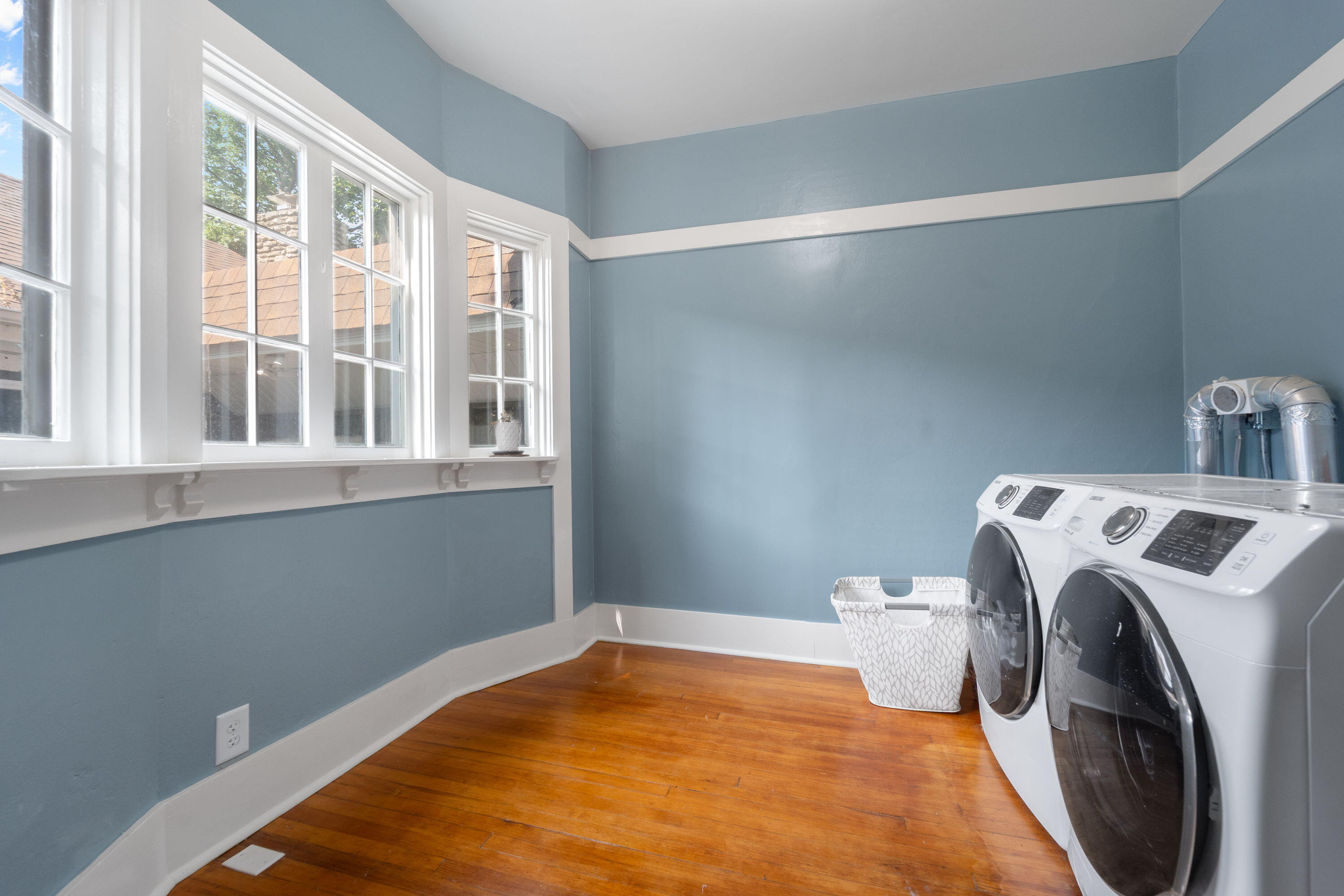 1213 College Avenue Racine, WI 53403 - Photo 16 of 31 Expansive walk-in closet off the master bedroom with an attached laundry area—blending luxury, convenience, and smart storage in one elegant space.