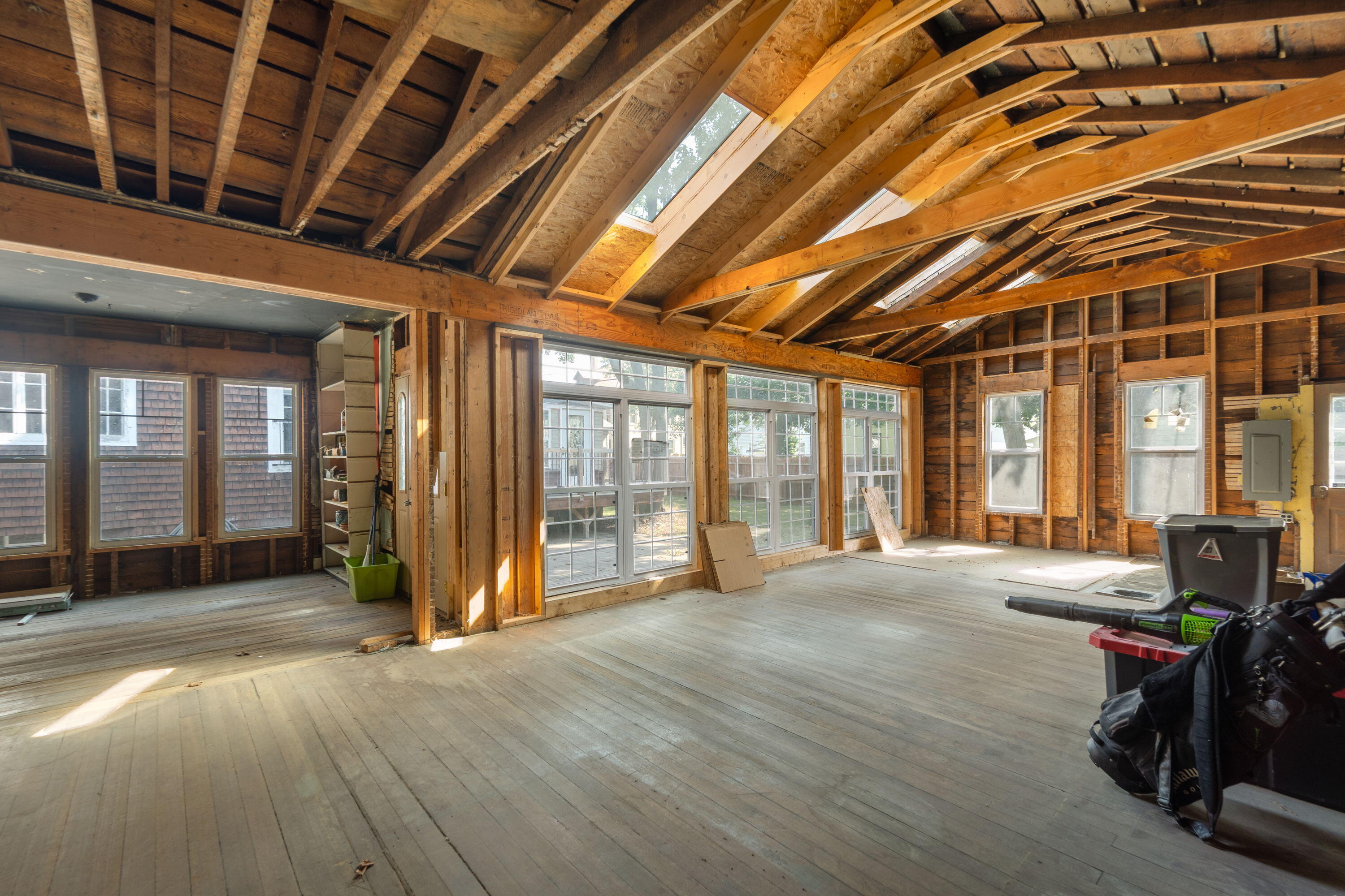 1213 College Avenue Racine, WI 53403 - Photo 24 of 31 Separate space behind the garage—once an art studio, now a gutted blank canvas with vaulted ceilings, new windows, and skylights. Transform it into storage, a mother-in-law suite, accessory unit, or income-producing rental—the possibilities are endless.