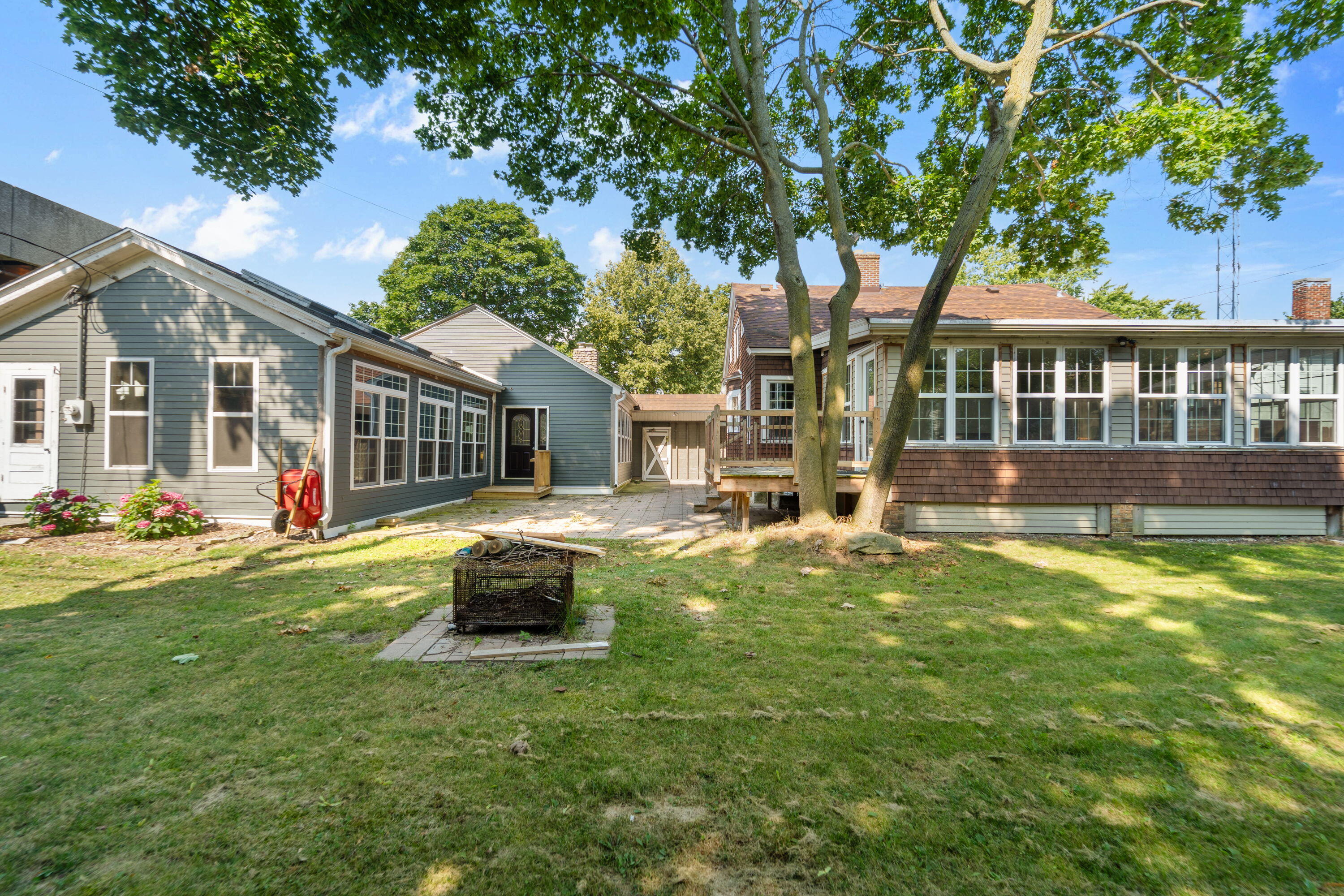 1213 College Avenue Racine, WI 53403 - Photo 27 of 31 Expansive fenced yard with a cozy fire pit—perfect for lively gatherings, outdoor play, and year-round enjoyment in your own private oasis.