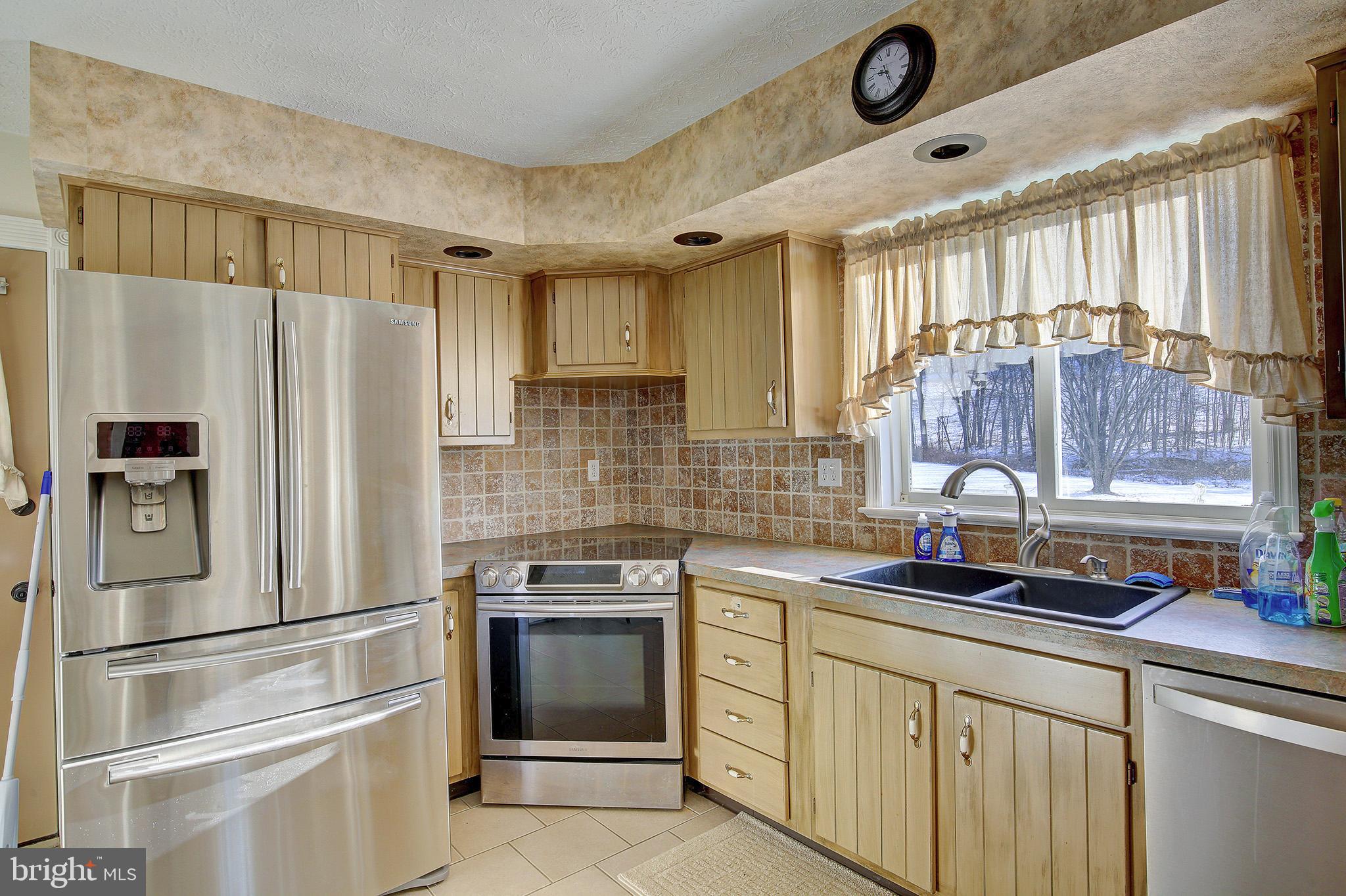 241 Earth Station Road Catawissa, PA 17820 - Photo 13 of 18 a kitchen with stainless steel appliances granite countertop a refrigerator sink and stove