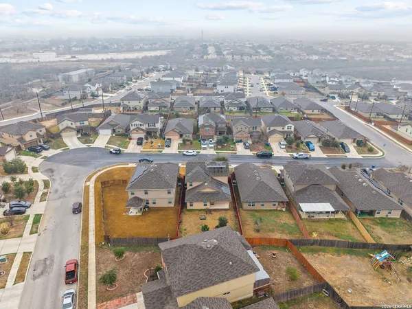 an aerial view of residential houses with outdoor space