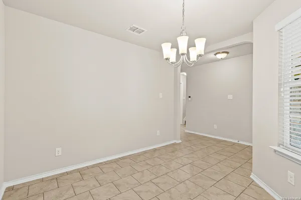 a view of a chandelier fan and wood floor