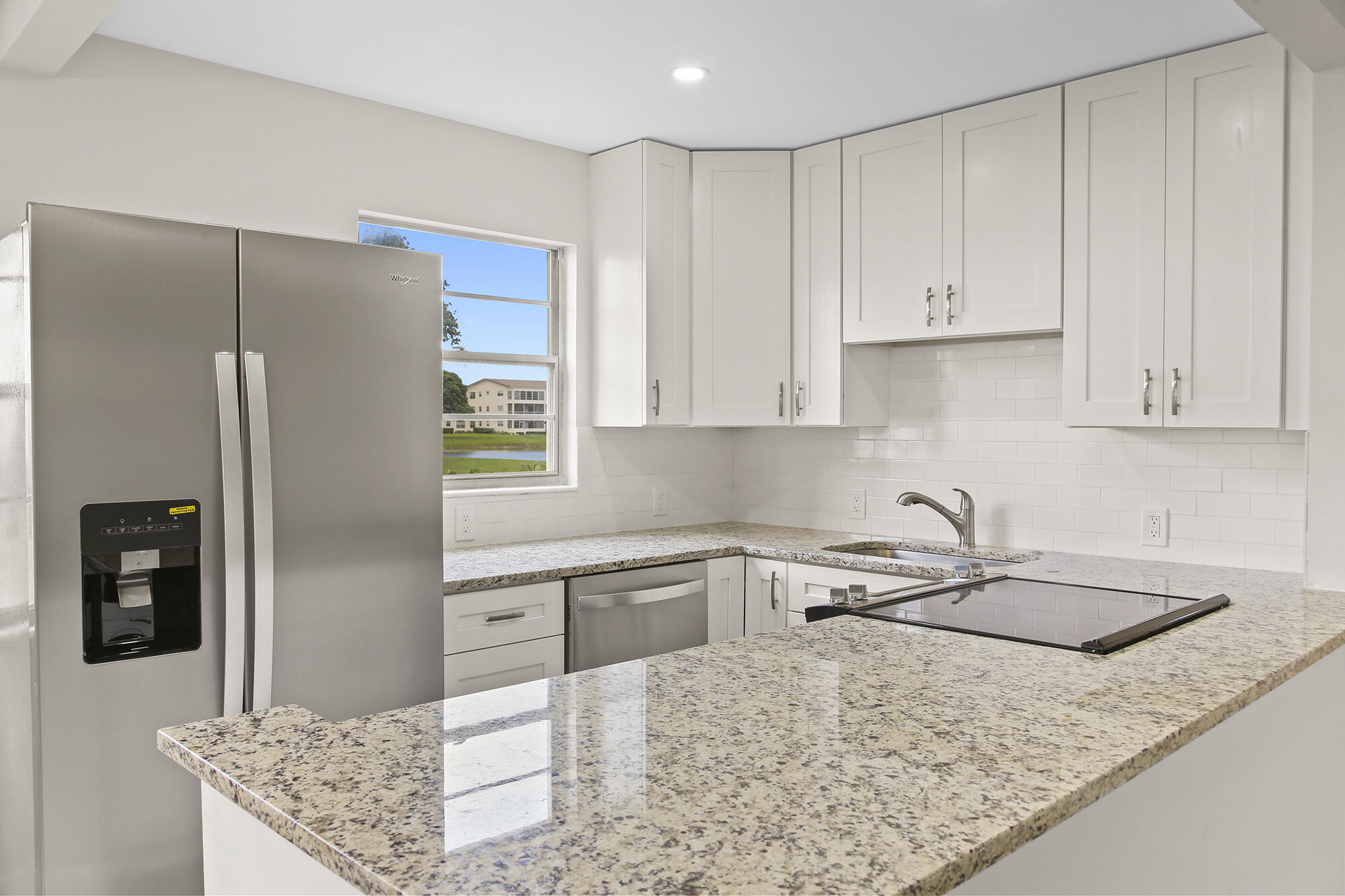 182 Preston F, Unit 182 Boca Raton, FL 33434 - Photo 1 of 17 a kitchen with stainless steel appliances granite countertop a sink a refrigerator and a granite counter tops