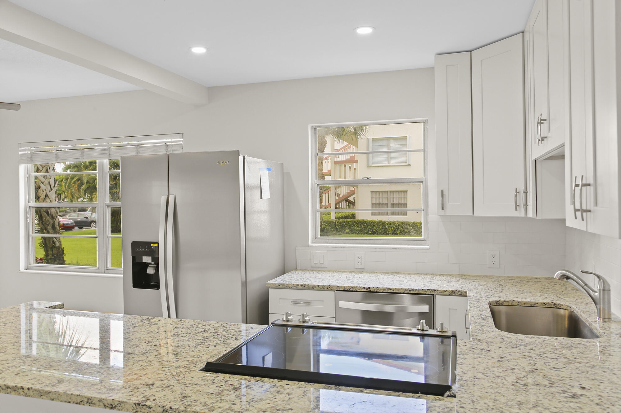 182 Preston F, Unit 182 Boca Raton, FL 33434 - Photo 2 of 17 a kitchen with stainless steel appliances granite countertop a refrigerator and a sink