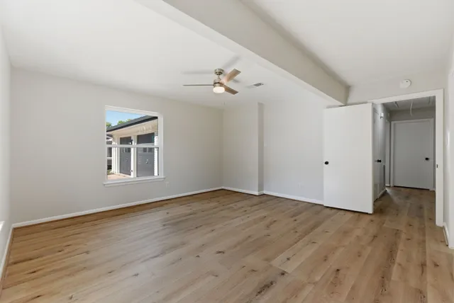 wooden floor in an empty room with a window