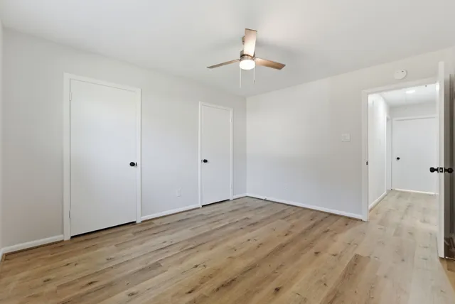 a view of an empty room with wooden floor