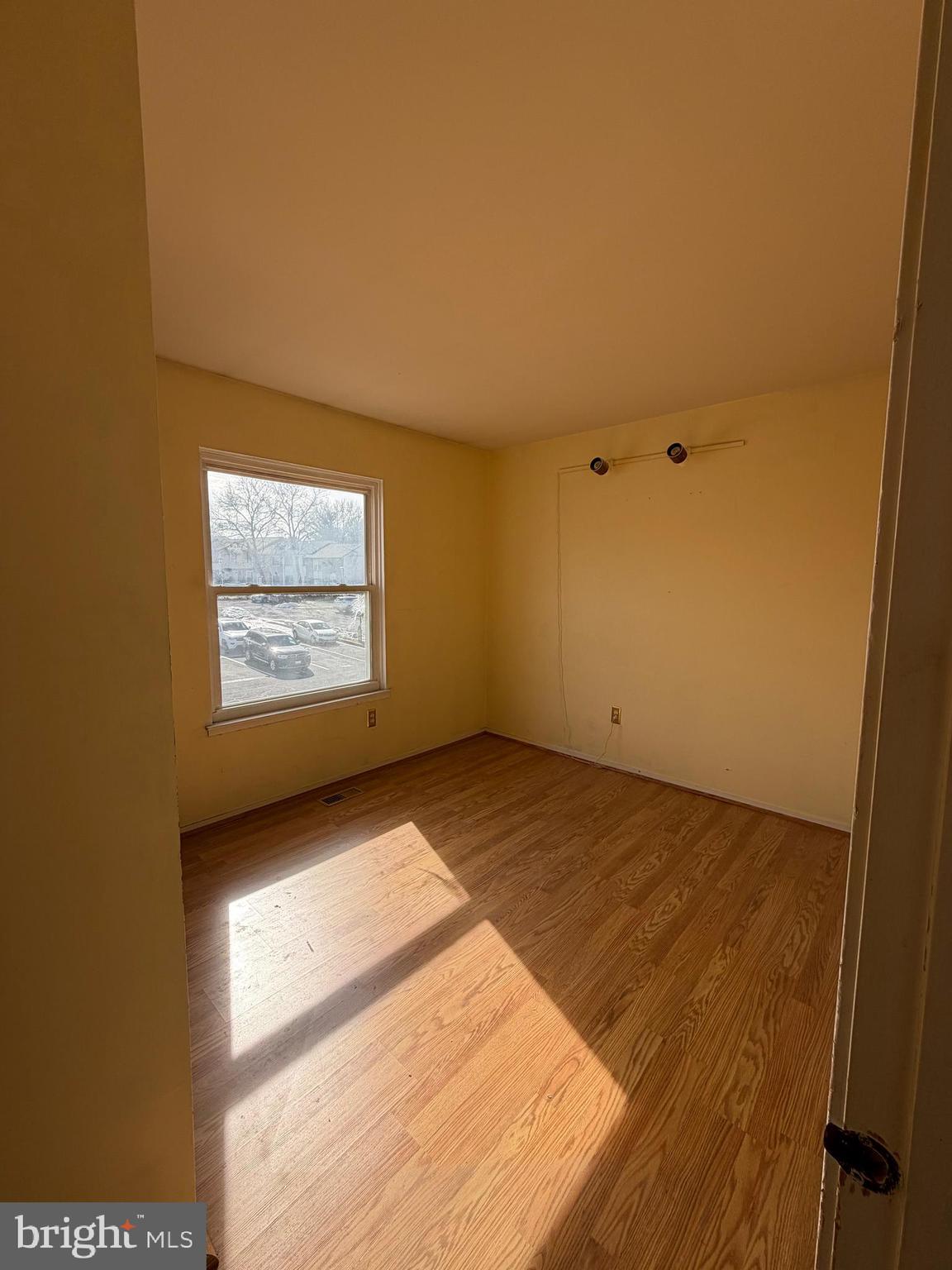 56 Apple Way Frederick, MD 21703 - Photo 12 of 14 an empty room with wooden floor and windows