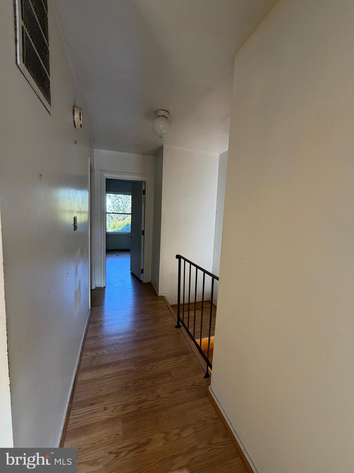 56 Apple Way Frederick, MD 21703 - Photo 8 of 14 a view of a hallway with wooden floor and stairs