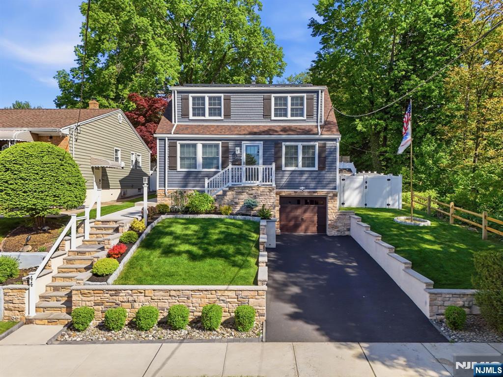 44 Alpine Place Kearny, NJ 07032 - Photo 4 of 50 a front view of a house with a garden and plants