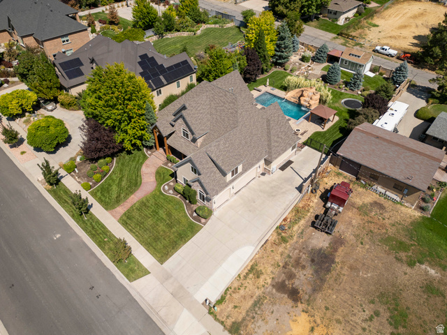 687 South 2080th Street East Springville, UT 84663 - Photo 74 of 149 Expansive property featuring a multi-level home with a gabled roofline, a concrete driveway, and a large backyard with a swimming pool