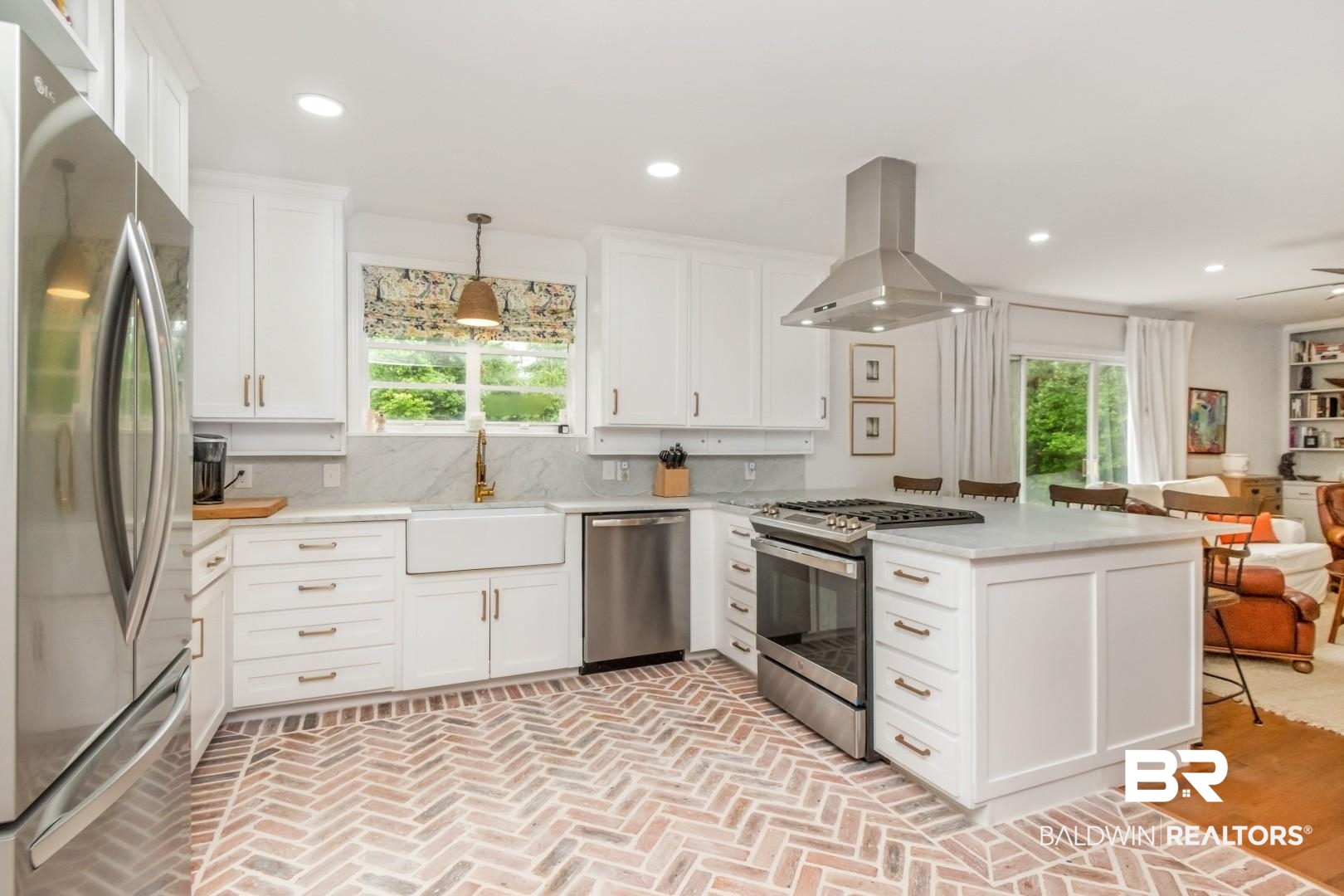 4596 Hawthorne Place Mobile, AL 36608 - Photo 11 of 34 Kitchen featuring herringbone brick flooring, white cabinetry, a large kitchen island, stainless steel appliances, and a farmhouse sink