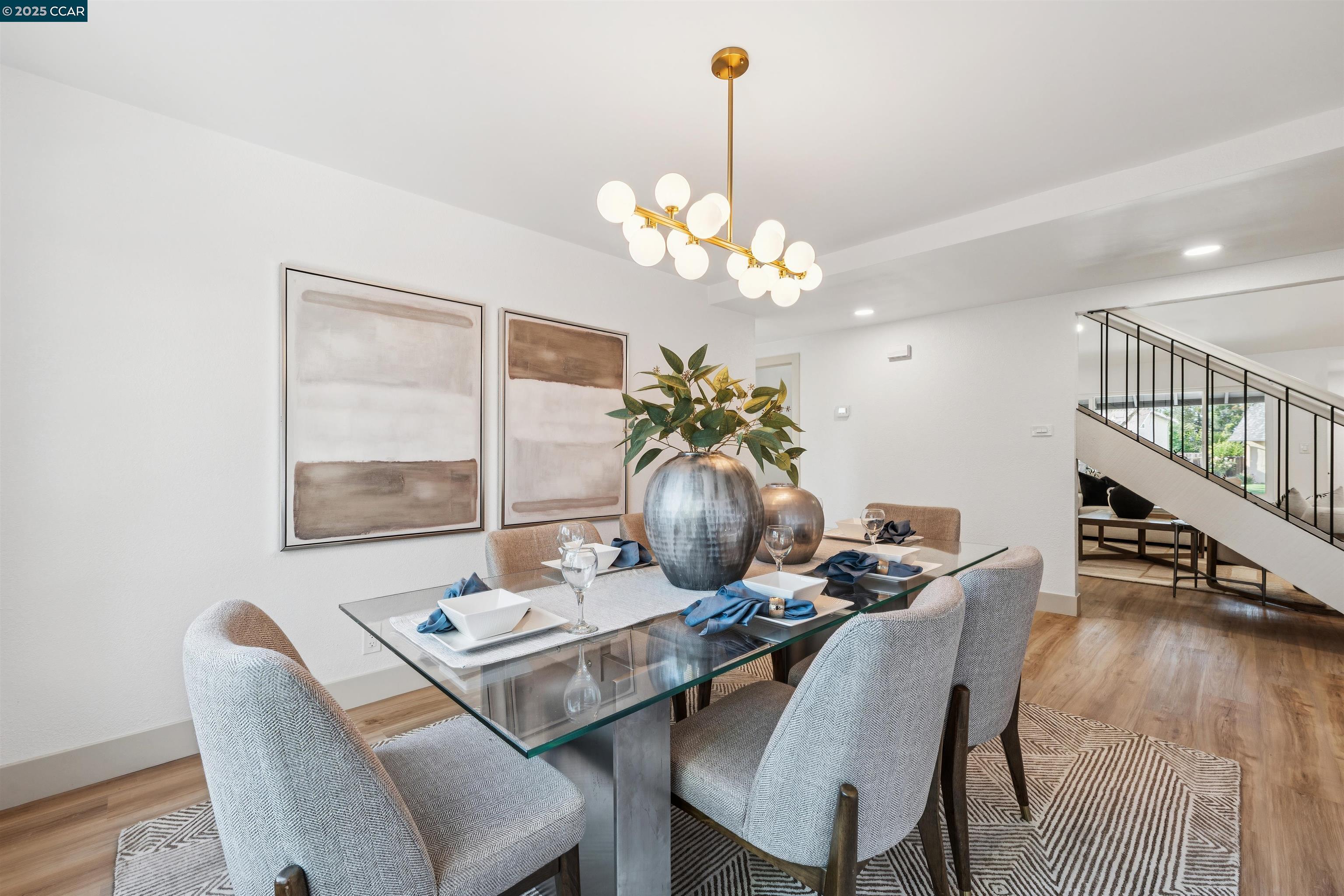 6 San Pedro Place San Ramon, CA 94583 - Photo 19 of 57 a dining room with furniture a chandelier and wooden floor