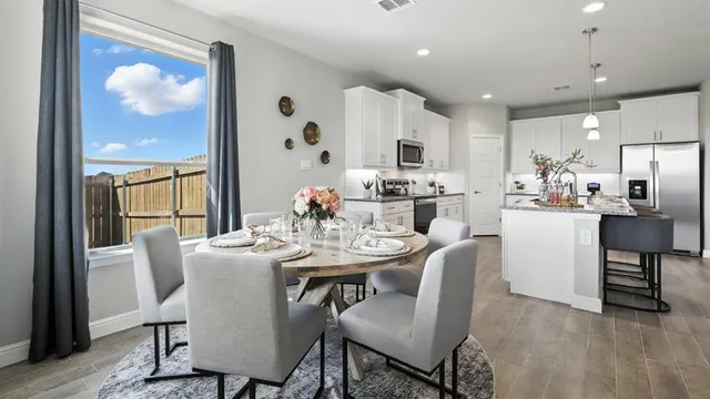 a dining room with furniture a rug and wooden floor