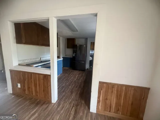 a view of a kitchen from the hallway