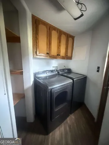 a utility room with sink dryer and washer